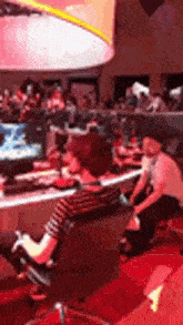 a man is sitting in a chair playing a video game in a room .