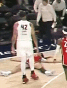 a basketball player wearing a white jersey with the number 42 on the back