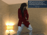 a man in a red robe is dancing in front of a sign that says " spitgate 2 "