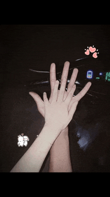 a man and a woman are holding their hands in front of a motorcycle .