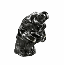 four statue of a man sitting on a rock