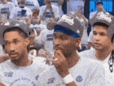 a group of people wearing oklahoma city t-shirts are watching a game