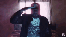 a man wearing a t-shirt that says doo on it salutes