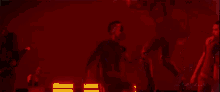 ariana grande is dancing with a man in a dark room .