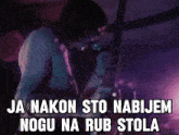 a man singing into a microphone with the words " ja nakon sto nabijem nogu na rub stola " written below him