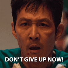 a man in a green shirt says don 't give up now