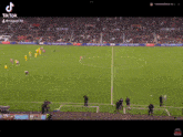 a soccer game is being played in a stadium sponsored by sky
