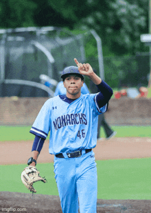 a baseball player wearing a blue monarchs jersey