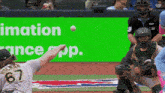 a baseball player wearing number 67 throws a ball