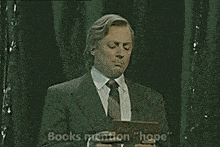 a man in a suit and tie is saying " books mention hope "