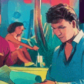 a man in a blue shirt is sitting in front of a woman in a pink dress