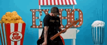 a man playing a guitar in front of a sign that says echo on it