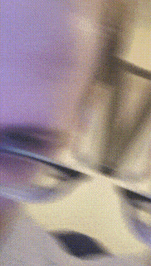 a blurry picture of a person 's face with a purple and yellow background