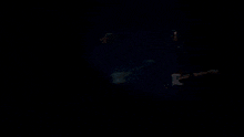 a silhouette of a person standing in a dark room with smoke coming out of it