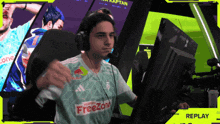 a man wearing headphones and a shirt that says freezone on it