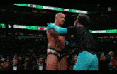 a blurred image of a wrestling ring with a sign that says mania