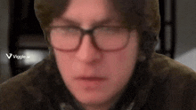 a blurry picture of a man with glasses and a viggle.ai logo