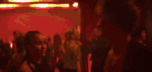 a blurry picture of people dancing in a club