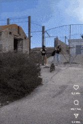 two women standing in front of a fence with one wearing a shirt that says ' i love you '