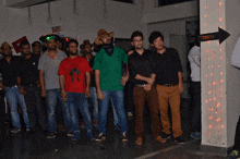 a group of young men are posing for a picture in front of a sign that says theatre