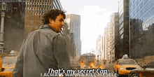 a man is standing in the middle of a city street and talking to a woman .