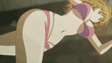 a girl in a pink bikini is laying down
