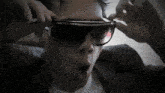a close up of a person wearing sunglasses and a suit