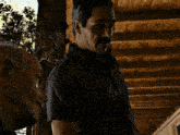 a man with a mustache and a tattoo on his arm is talking to another man