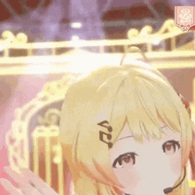a 3d anime girl with blonde hair and a microphone on her head is standing on a stage .