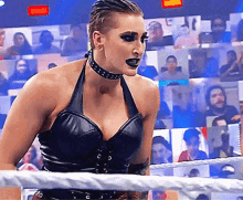 a woman wearing a choker is standing in a ring