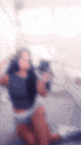 a blurry picture of a woman kneeling down on the floor