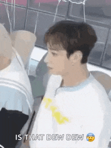 a man in a white shirt is standing next to another man in a white shirt and saying `` is that dew dew '' .