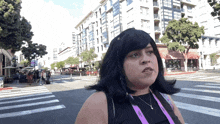 a woman with a lanyard around her neck that says nikon