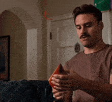 a man with a watch on his wrist is eating a piece of food