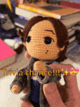 a person is holding a crocheted doll with the words trivia chance written on it