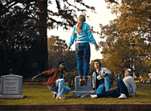a group of people are posing for a picture in front of a grave of casey cole