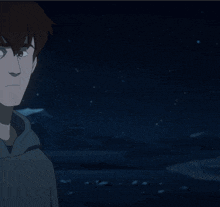 a man in a hoodie stands in front of a blue light