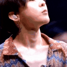 a close up of a person 's neck and ear while wearing earrings .