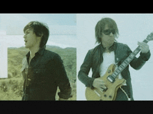 two men are standing next to each other , one is playing a guitar .