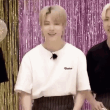 a close up of a person wearing a white t-shirt and striped pants .