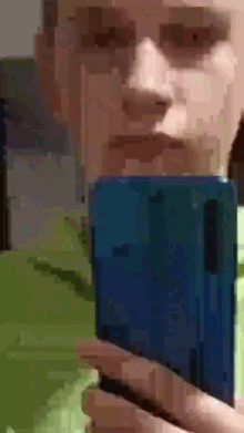 a pixelated image of a person holding a blue item in their hand .