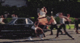 a group of people are jumping in the air while a woman in a bra stands in the middle