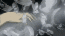a close up of a person 's hand in a cloudy area