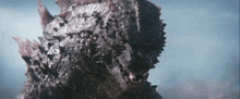a close up of a monster 's face with spikes on it .