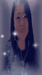 a woman wearing earbuds looks at the camera