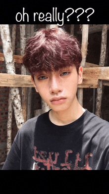 a young man with red hair is wearing a black shirt that says tsv