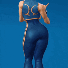 a woman in a blue jumpsuit with a yellow stripe on the side is standing in front of a blue background .