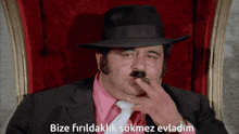 a man wearing a hat and tie smoking a cigar with the words bize firldaklik sokmez evladim written below him