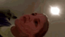 a close up of a person 's face with a light behind it