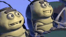 two cartoon bees are sitting next to each other on a green surface and smiling .